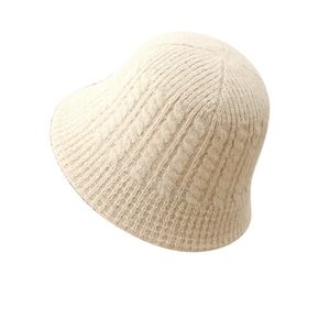 Beige knit bucket hat with cozy cable knit pattern for winter warmth and casual style