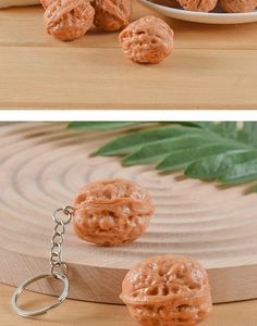Detail of realistic PVC walnut keychain showing textured surface and metal ring