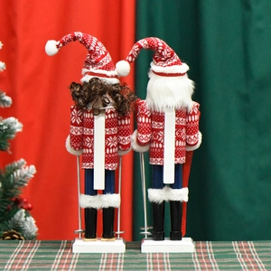 Skiing nutcracker soldiers in red and white outfits with ski poles for Christmas decor