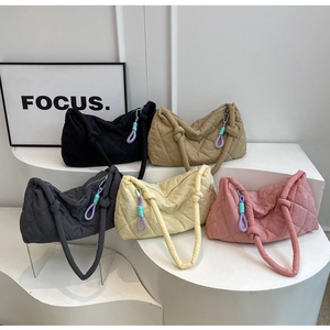 Detailed display of quilted shoulder bags in five colors with unique knotted handles