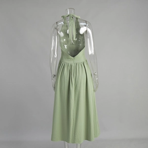 Detailed back view of a mint green halter neck cotton midi dress with open back design