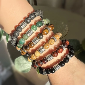 Detailed shot of layered natural stone bead bracelets with silver metal spacers on a wrist