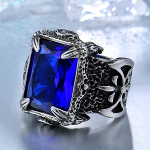 Macro view of vintage stainless steel ring with blue gem and cross pattern detail