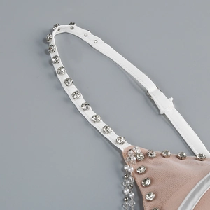 Detailed close-up of white mesh straps featuring sequins and sparkling rhinestone chains
