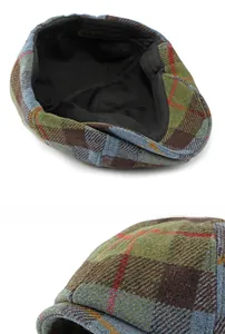 Macro shot of multi-color plaid newsboy cap showing wool fabric texture and inner lining