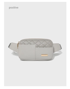 Detailed view of grey quilted PU leather waist bag with golden metal zipper and emblem