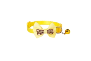 Detail of yellow nylon pet collar with double bowknot and golden metal bell for cats
