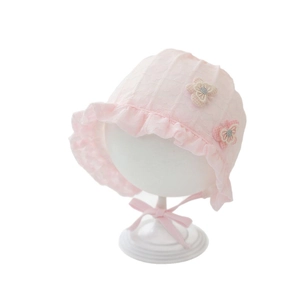 Pink lace baby sun bonnet with floral embroidery and ruffle trim on white model