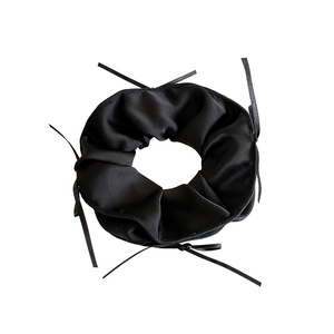 French style black satin scrunchie with long decorative ribbons on white background