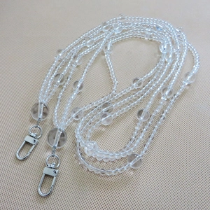 Detail of transparent acrylic beaded bag strap with silver metal swivel lobster clasps