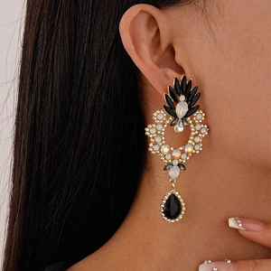 Vintage floral geometric drop earrings with black pear crystals on female model