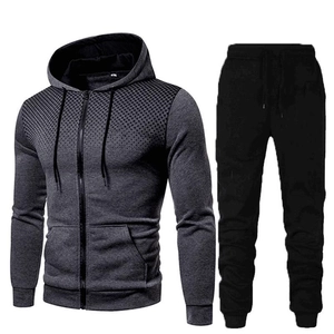 Detail of gray hoodie and black jogger pants featuring dot pattern on shoulders