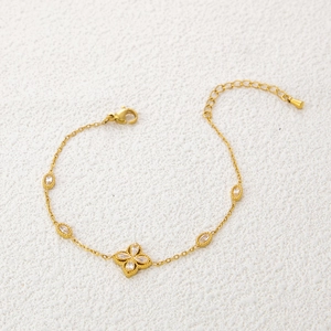 Detail view of gold clover bracelet with crystal zircons and adjustable lobster clasp
