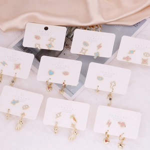 Detailed close-up of gold-plated earring set featuring zircon and colorful oil drip designs