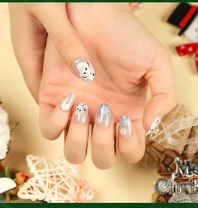 Detail of Christmas press-on nails with 3D snowman, white snowflakes and silver glitter