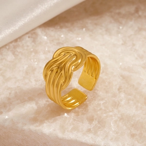 Elegant 18K gold plated stainless steel adjustable knot ring on white crystal