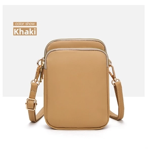 Detail of khaki canvas mobile phone crossbody bag with double zippers and gold hardware