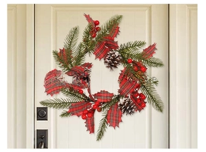 Christmas wreath with pine cones and red berries on a white front door background