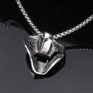 Silver stainless steel demon fangs mask pendant with box chain on reflective background