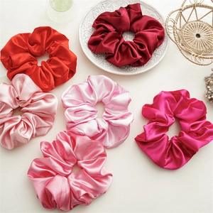 Large solid color satin scrunchies set in various red and pink silk textures