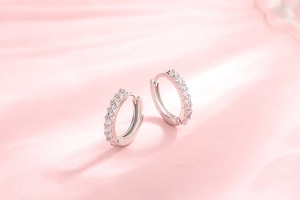 Detailed macro view of S925 sterling silver hoop earrings with clear zircon stones