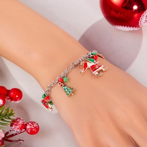 Close-up of a festive Christmas bracelet with Santa Claus and reindeer charms on a wrist