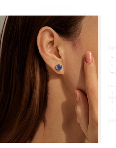 Macro shot of 8mm round blue tanzanite-colored stud earrings in S925 sterling silver