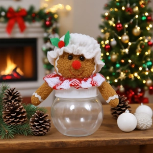 Gingerbread man themed clear Christmas candy jar with festive plush cap and scarf