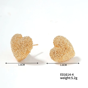 Detailed view of gold heart stud earrings with grainy frosted texture and size markings