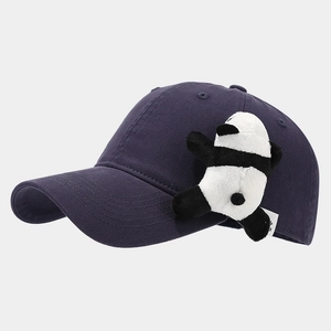Detail view of cotton baseball cap with cute plush panda ornament and smooth purple fabric