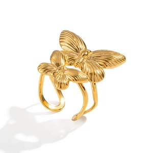 Detail of 18K gold butterfly open ring featuring dual textured charms on white background