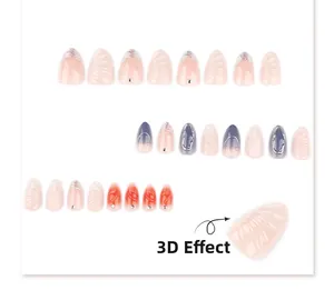Détail de faux ongles amande courts effet 3D avec dégradés de couleurs et strass
