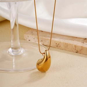 Minimalist golden teardrop pendant necklace with a polished mirror finish on snake chain