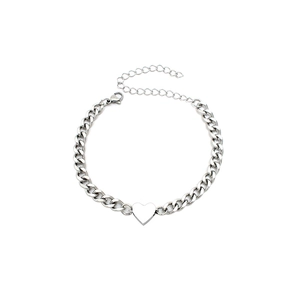 Detail of silver Cuban link bracelet featuring a magnetic heart charm and adjustable chain