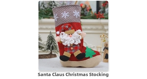 Detail of a red Christmas stocking featuring a 3D Santa doll and green tree applique