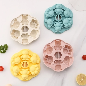 Silicone bear and paw shaped baby food steaming molds in beige, blue, yellow, and pink