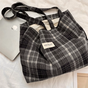 Detail view of large checkered wool tote bag with magnetic closure and inner lining