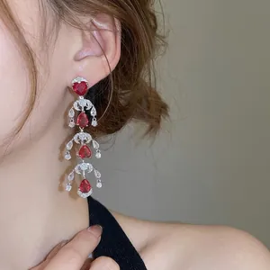 Luxury silver chandelier earrings with heart and teardrop shaped red rubies and zircons
