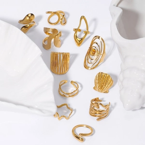 Minimalist 18k gold plated stainless steel star and shell rings set in a modern display