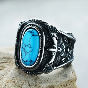 Vintage eagle turquoise ring in antique silver finish for men on a stone background