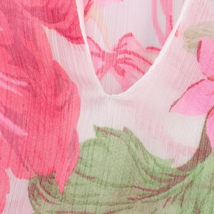 Close-up of the V-neck design and delicate floral print on a lightweight chiffon shirt