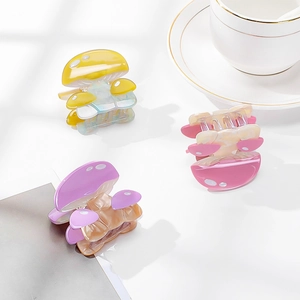 Three acetate mushroom hair claws in yellow, pink and purple with a pearly finish