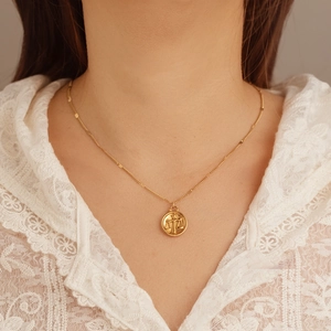 Gold Libra zodiac coin pendant necklace on model with stainless steel cable chain