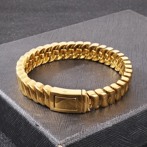 Macro view of gold stainless steel heavy curb chain bracelet with rectangular clasp