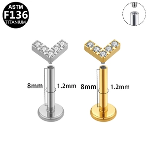 Detailed view of titanium V-shaped piercing studs in silver and gold with size specs