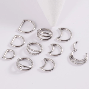 Detailed collection of silver G23 titanium nose rings with moon and droplet zircon designs