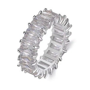 Eternity ring with baguette-cut white zircons in a silver-tone setting on white background