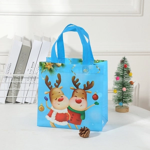 Detail of blue non-woven Christmas gift bag with cartoon reindeer and festive decorations