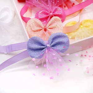 Detailed view of handmade lace pet hair bows with glitter fabric and polka dot mesh