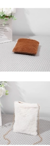 Detail of plush crossbody small square bags in brown and white with gold chain straps